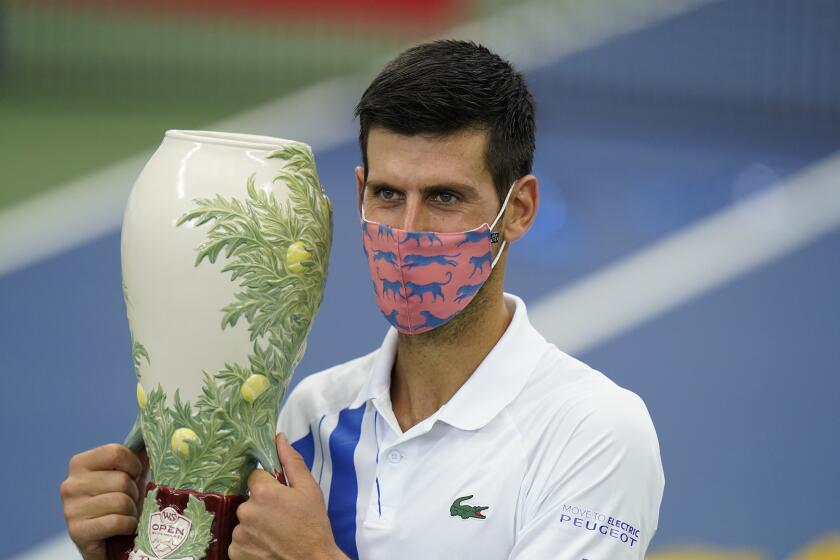 Novak Djokovic holds the championship trophy Aug. 29, 2020, after winning the Western & Southern Open in New York.