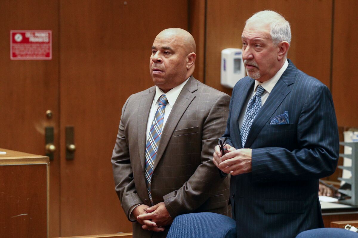 Matthew Fletcher stands next to his attorney