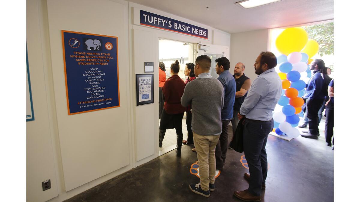 Guests walk into the new Tuffy's Basic Needs Center during the opening ceremony Wednesday on the Cal State Fullerton campus.