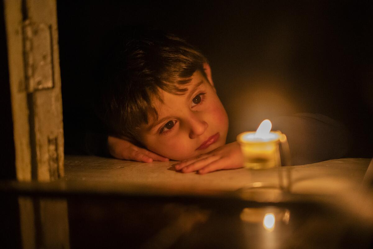 Boy gazing at a candle