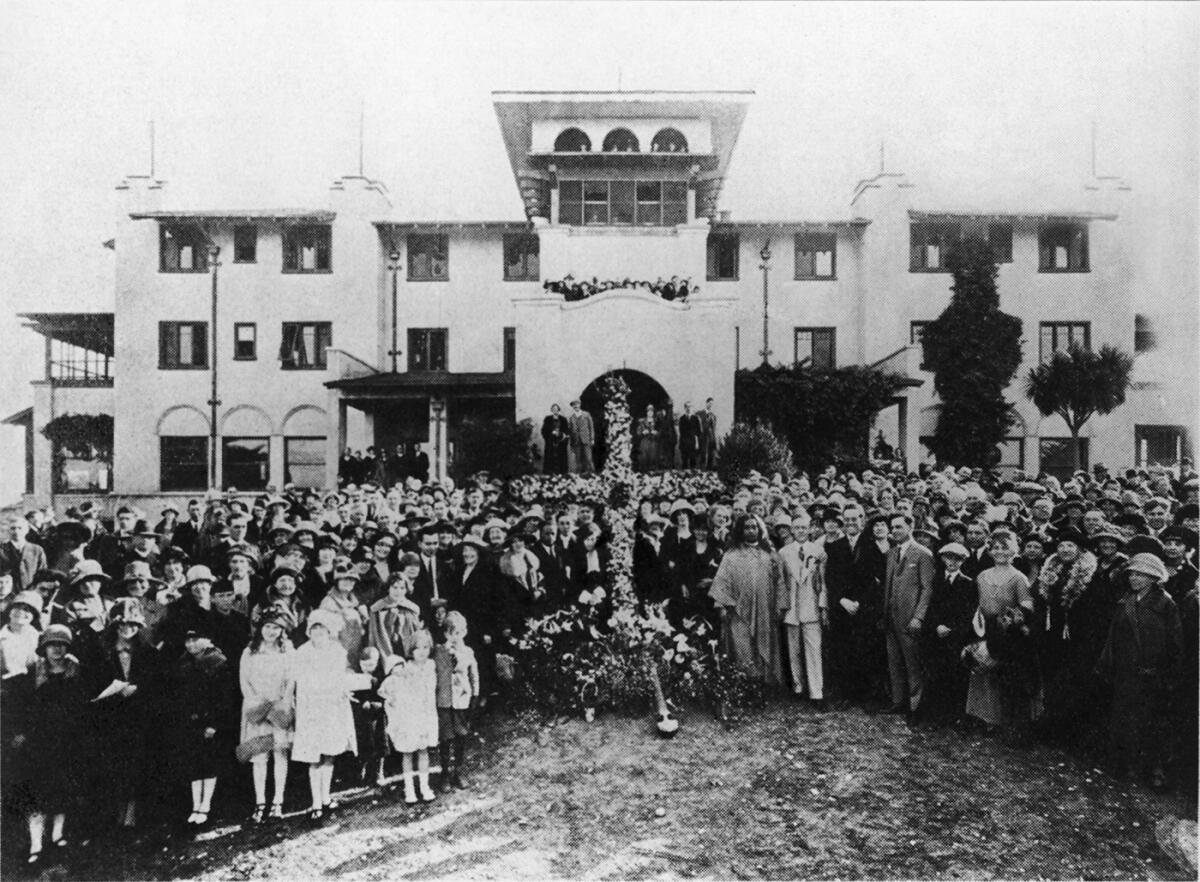 A large group of people in front of a big building 