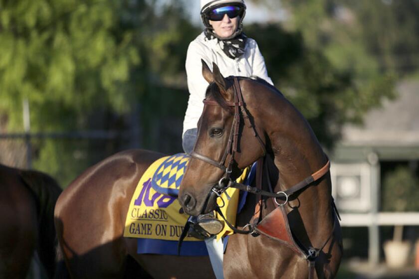 Game On Dude, with exercise rider Dana Barnes atop, gets ready for a morning workout at Santa Anita Park on Wednesday.
