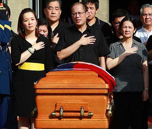 The children of the late former Philippine President Corazon Aquino sing the national anthem before the casket of their mother at the Manila Cathedral in the Philippines today. Aquino died Saturday at the age of 76.