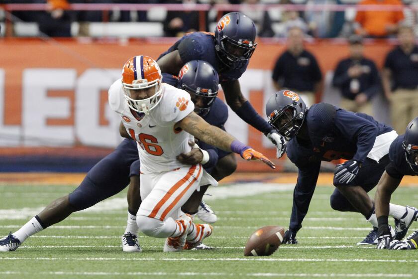 Clemson’s Jordan Leggett, left, dives for a loose ball against Syracuse on Saturday.