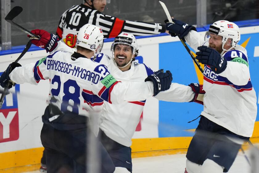 Norway's Michael Brandsegg-Nygard, left, celebrates with Norway's Mats Zuccarello, center, and Norway's Patrick Thoresen after scoring his sides first goal during the preliminary round match between Denmark and Norway at the Ice Hockey World Championships in Prague, Czech Republic, Tuesday, May 14, 2024. (AP Photo/Petr David Josek)