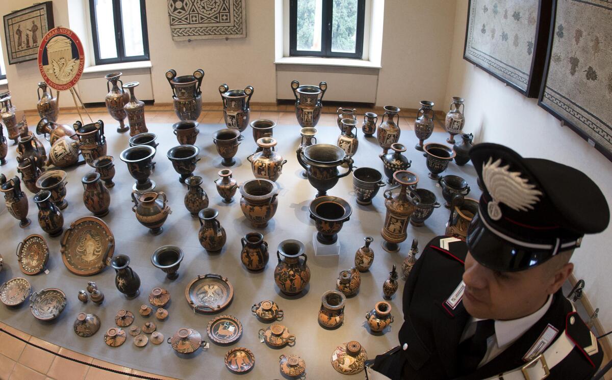Looted antiquities recovered by Italian authorities are displayed in Rome during a news conference last week. The record haul was found in a Swiss warehouse belonging to a Sicilian art dealer accused of being part of a trafficking network.