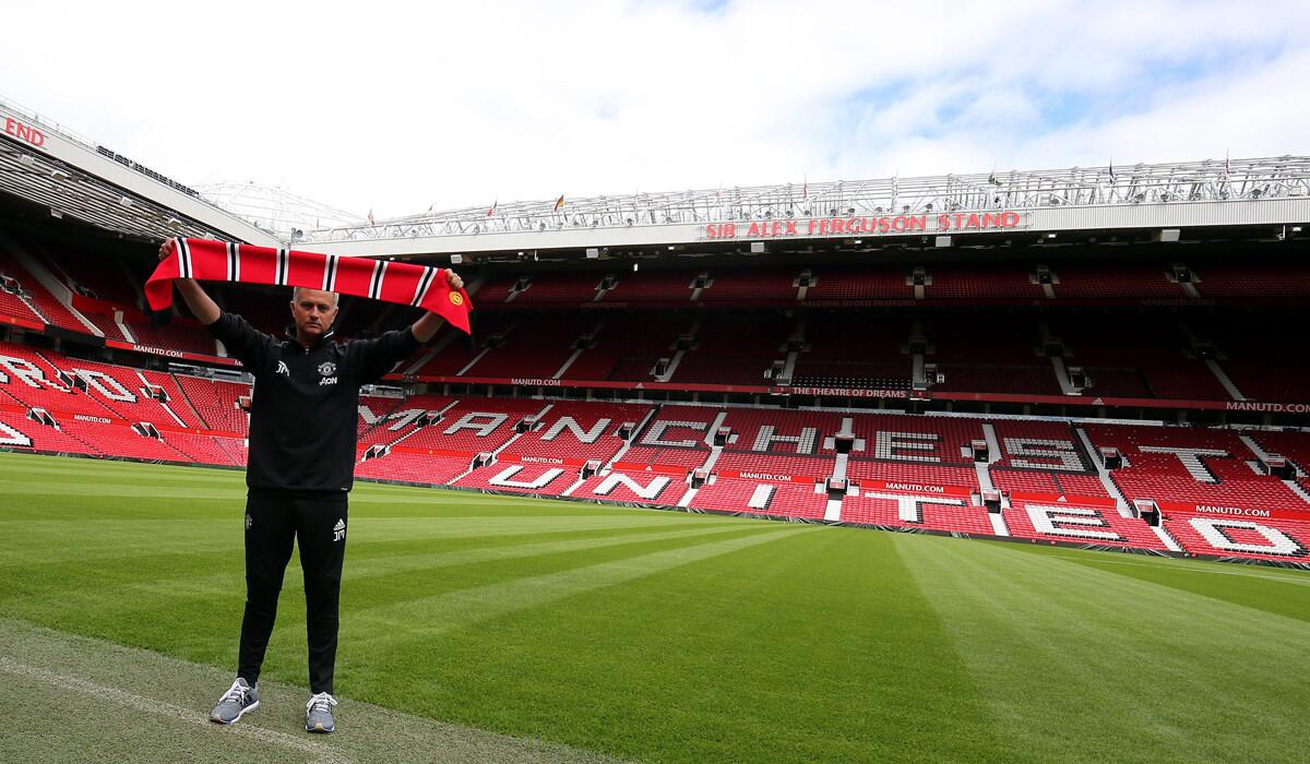 Manchester United's new manager, Jose Mourinho, poses for pictures at Old Trafford Stadium in Manchester, England, on July 5.