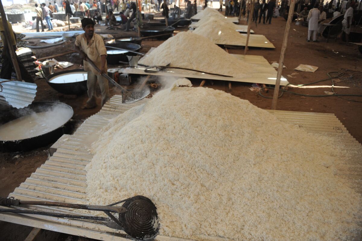 Indian cooks prepare basmati rice during the Brahma Chorayasi festival in Ahmedabad on Feb. 26, 2012. 