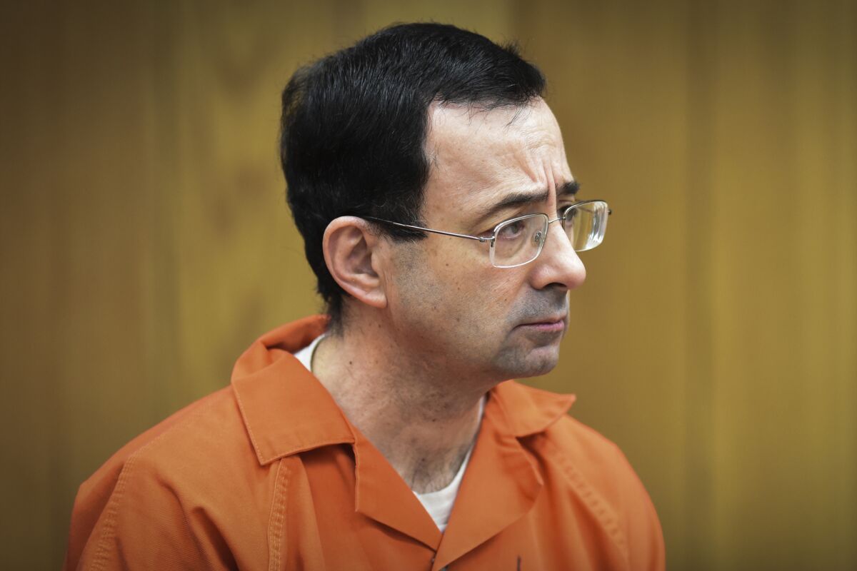 FILE - In this Feb. 5, 2018, file photo, Larry Nassar, former sports doctor who admitted molesting some of the nation's top gymnasts, appears in Eaton County Court in Charlotte, Mich. A judge dismissed criminal charges Wednesday May 13, 2020 against former Michigan State University President Lou Anna Simon arising from Nassar's sexual assault scandal. Simon was ordered to trial last year on charges that she lied to police about her knowledge of a sexual misconduct complaint against Nassar, who was a campus doctor and now is serving decades in prison. (Matthew Dae Smith/Lansing State Journal via AP, File)