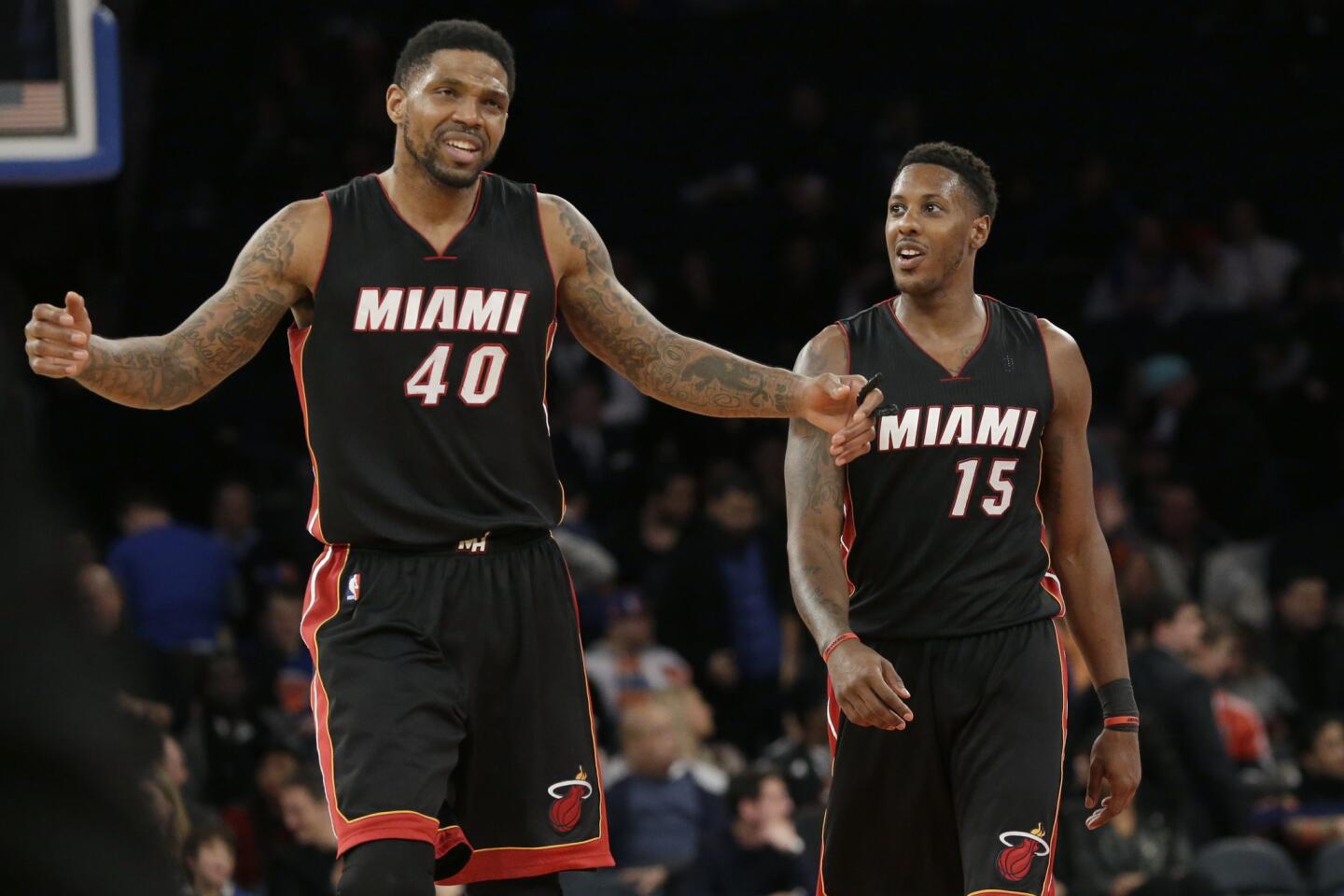 Miami Heat's Udonis Haslem (40) and guard Mario Chalmers react at the end of an NBA basketball game against the New York Knicks, Friday, Feb. 20, 2015, at Madison Square Garden in New York. The Heat won 111-87. (AP Photo/Mary Altaffer)