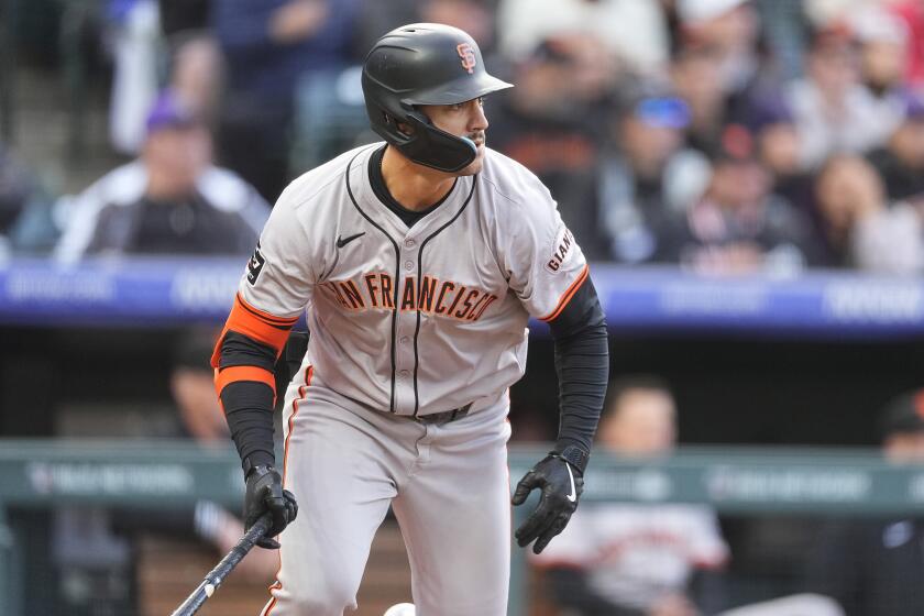 San Francisco Giants' Michael Conforto breaks from the batter's box after singling off Colorado Rockies starting pitcher Peter Lambert during the second inning of a baseball game Wednesday, May 8, 2024, in Denver. (AP Photo/David Zalubowski)