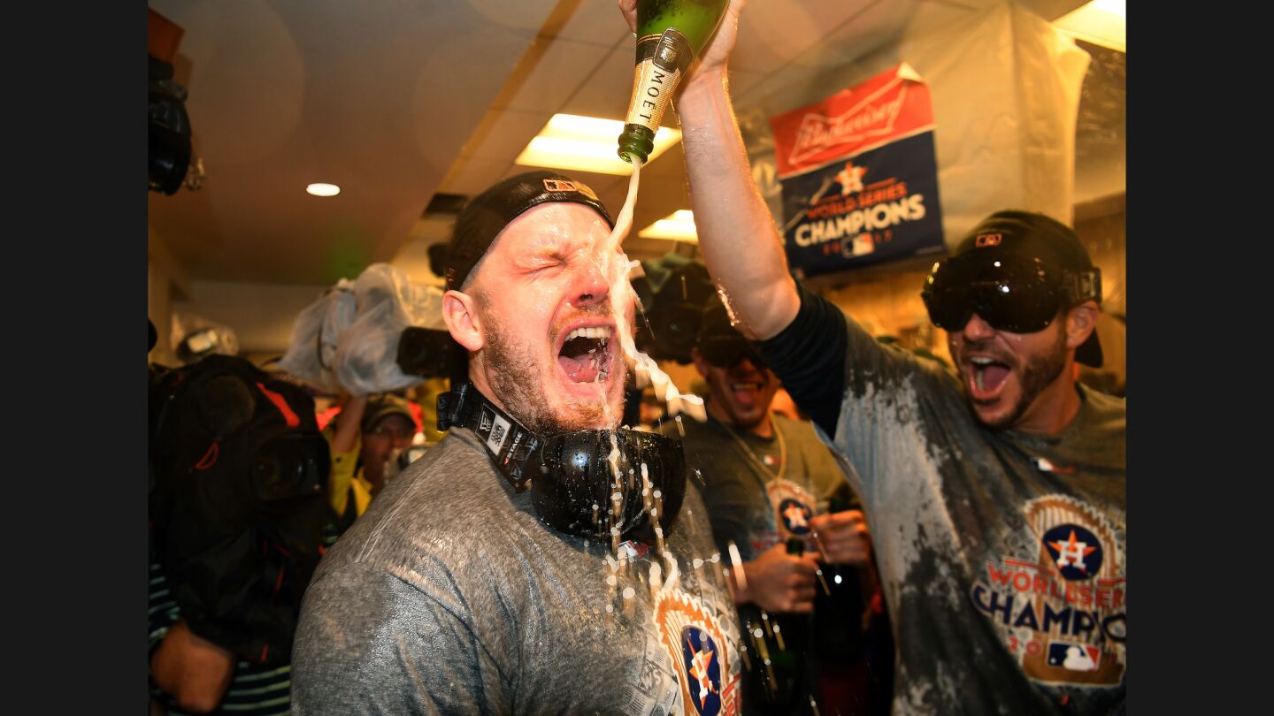 The Astros' Josh Reddick gets sprayed with champagne after his team defeated the Dodgers.