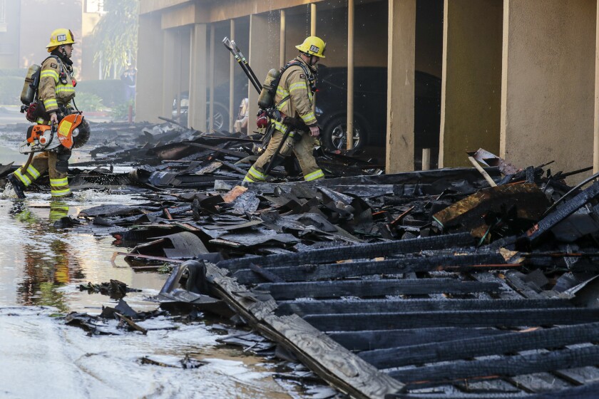 Firefighters at a burned-out building