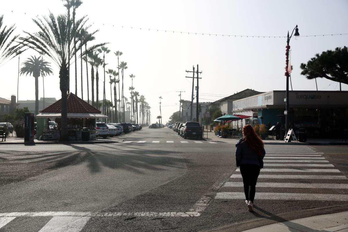 A pedestrian crosses a street in Redondo Beach