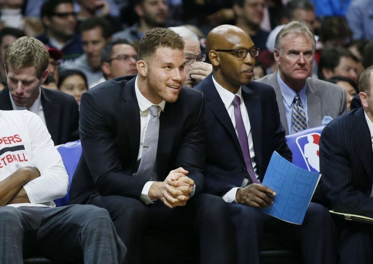 Clippers forward Blake Griffin sits on the bench with assistant coach Sam Cassell, right, during the second half of a game on Jan. 13.