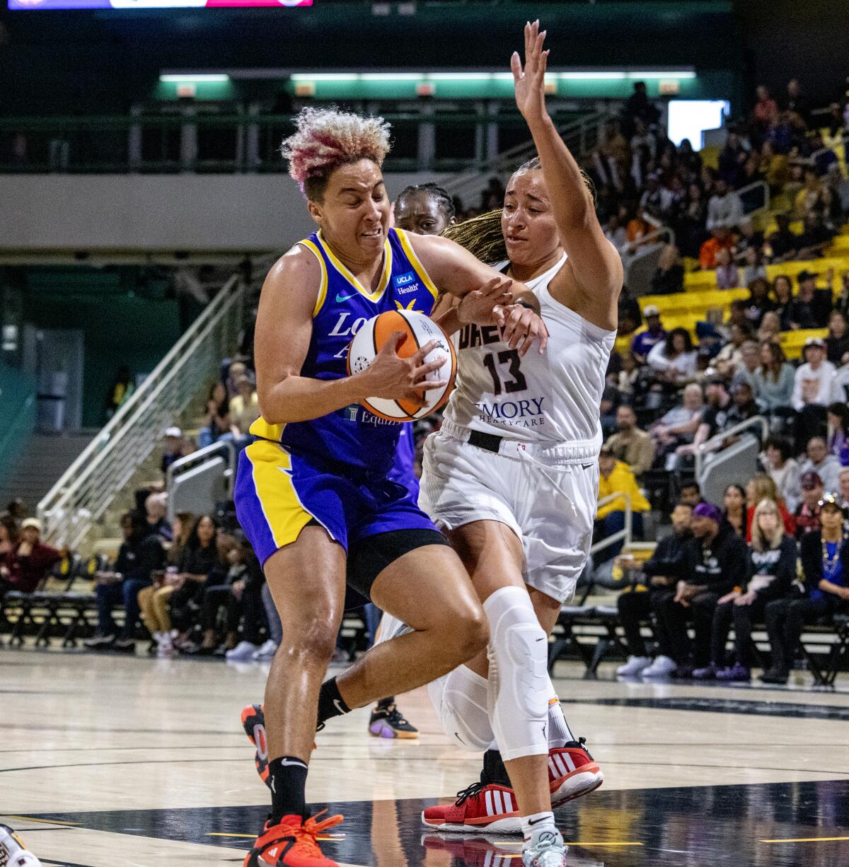 Sparks guard Layshia Clarendon drives to the basket under pressure from Atlanta Dream guard Haley Jones 