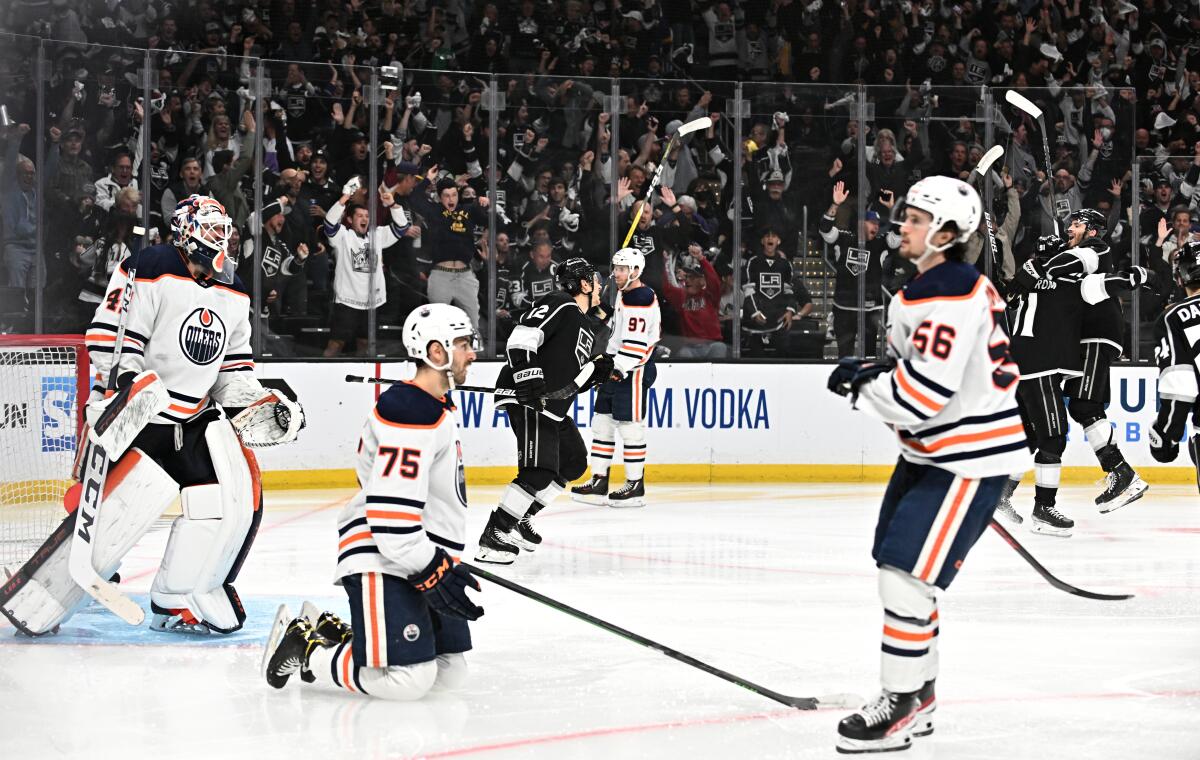 Kings player celebrate a goal against the Oilers.