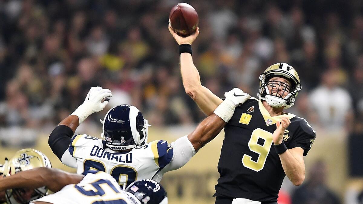 Rams' Aaron Donald gets an arm on New Orleans Saints quarterback Drew Brees at the Mercedes Benz Superdome on Nov. 4, 2018.
