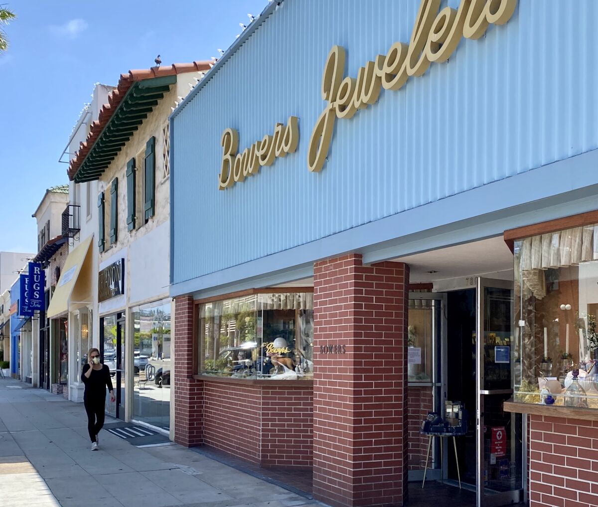 Several shops in La Jolla, including Bowers Jewelers on Girard Avenue, are open for curbside shopping, with a Safe Reopening Plan posted.