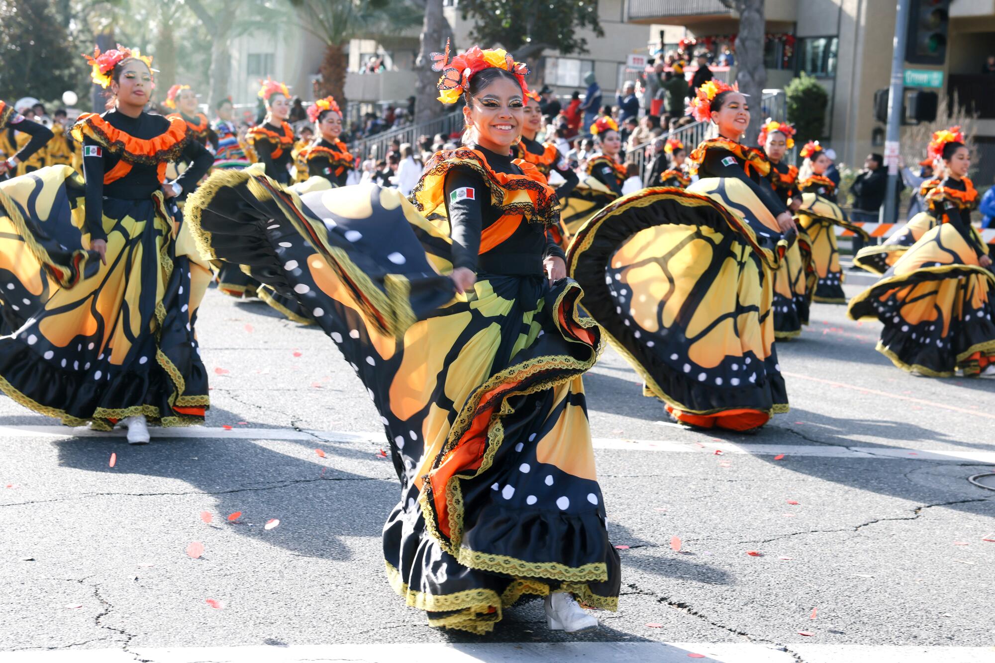 Dancers in gowns patterned after monarch butterflies