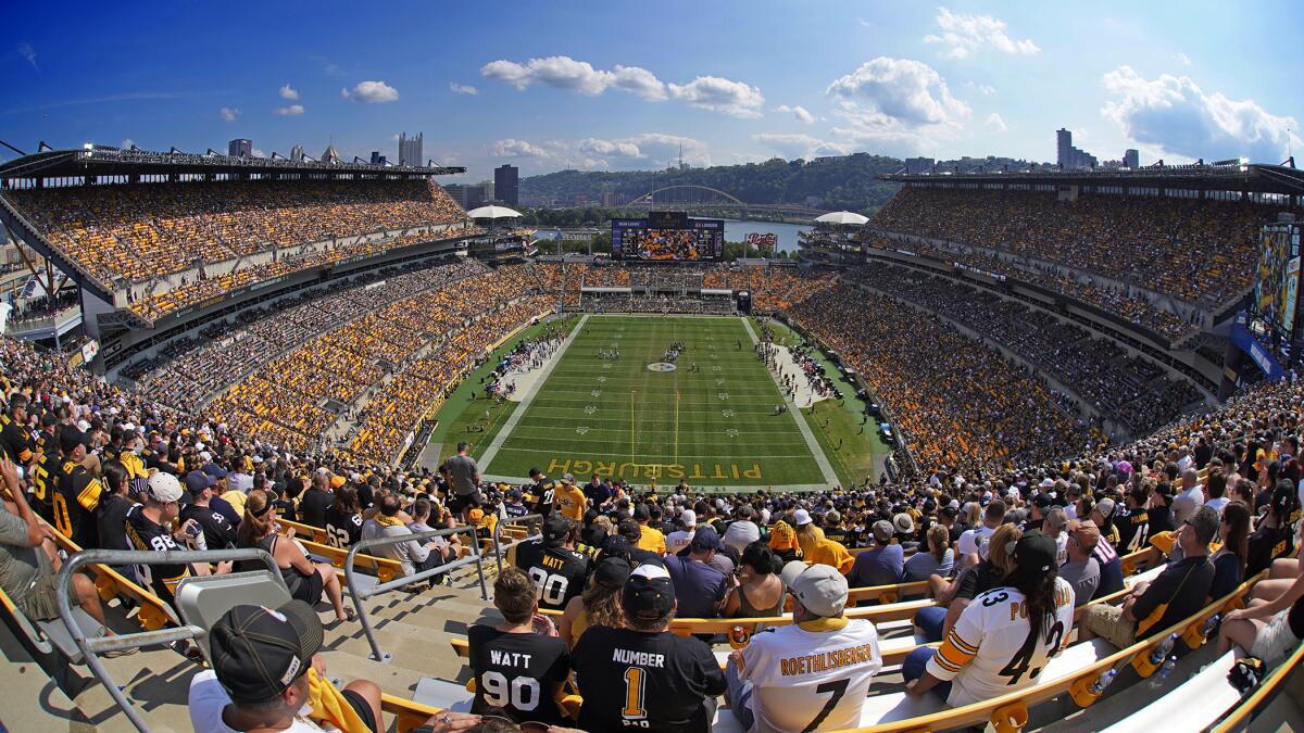 Fans watch a game between the Steelers and Patriots at Acrisure Stadium in Pittsburgh.