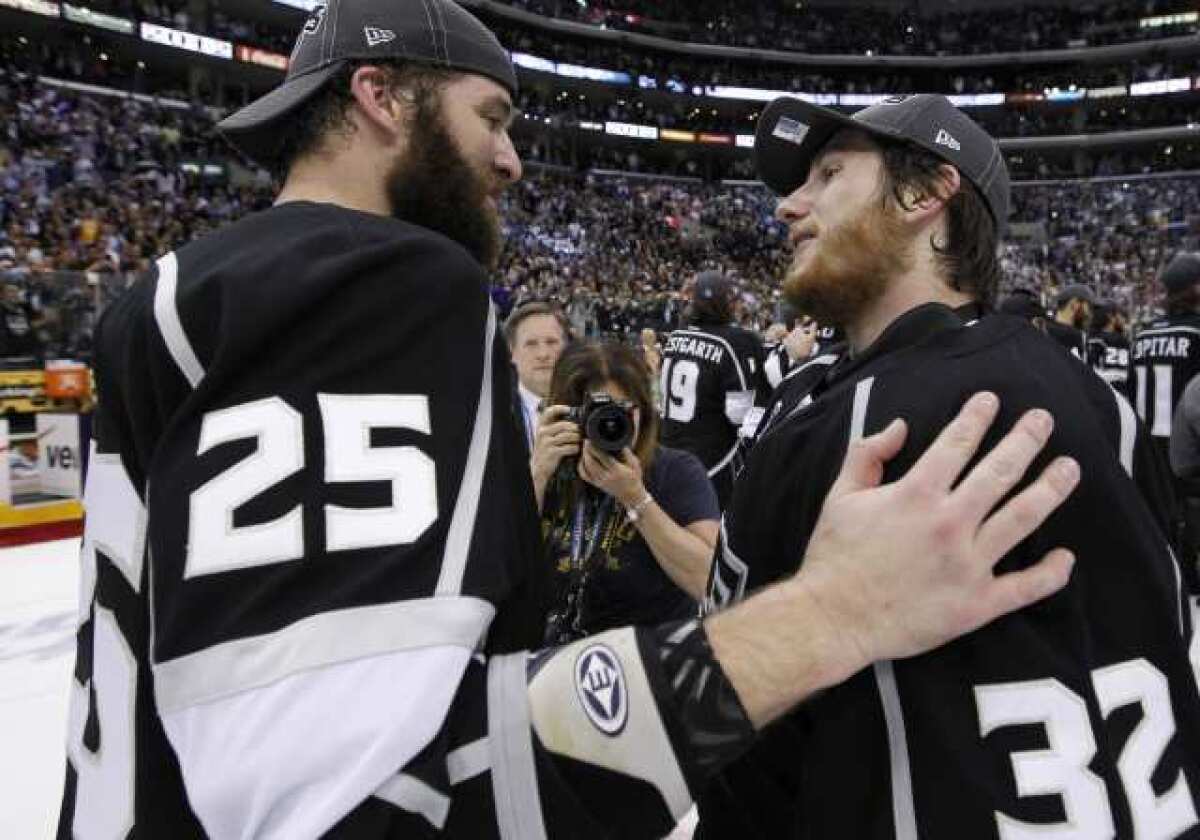 Dustin Penner, left, talks with teammate Jonathan Quick after the Kings won the Stanley Cup.
