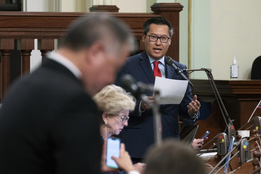 Assemblyman Vince Fong, R-Bakersfield, right, vice chair of the Assembly budget committee, criticizes the state budget plan carried by Assemblyman Phil Ting, D-San Francisco, left, the chair of the budget committee, at the Capitol in Sacramento, Calif., Tuesday, June 27, 2023. Both houses approved the $310.8 billion spending plan that covers the nearly $32 billion budget deficit without raiding the state's saving account. Fong noted the budget Democrats approved assumes much higher tax revenue than the projections from the nonpartisan Legislative Analyst's Office. (AP Photo/Rich Pedroncelli)
