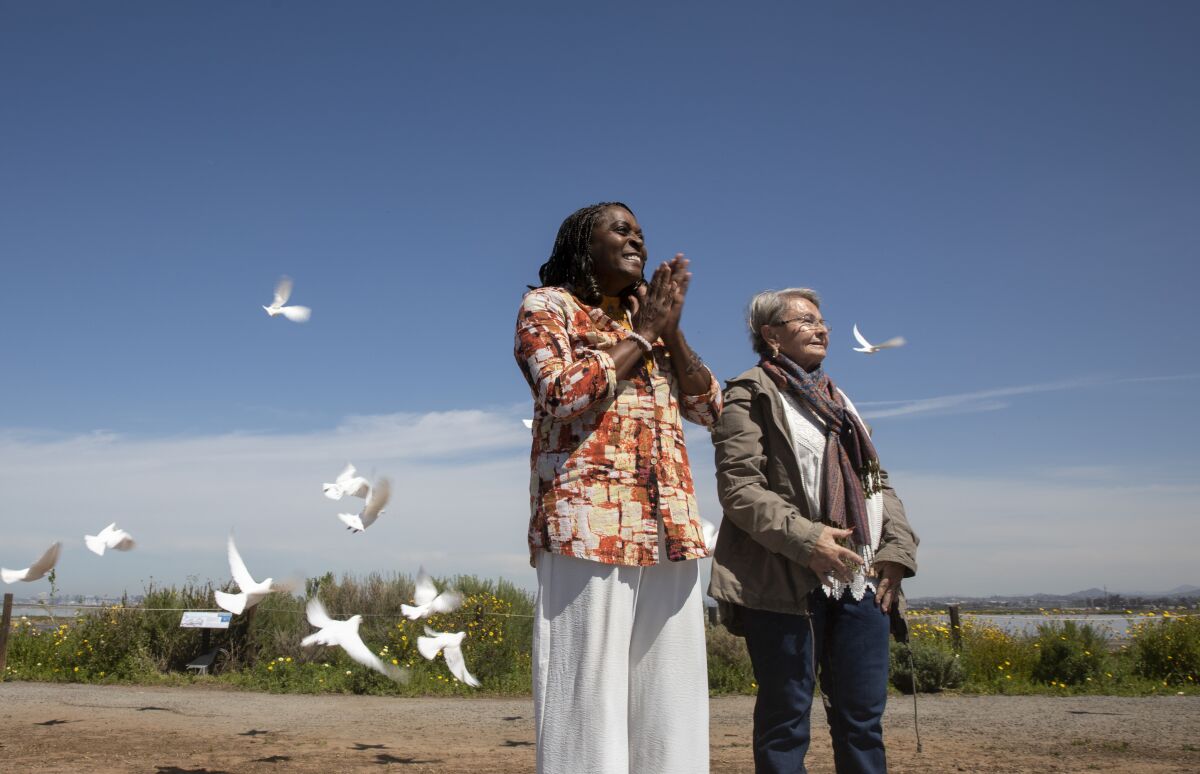 Milena (Sellers) Phillips and Maria Keever release doves in tribute to their sons who were murdered in 1993