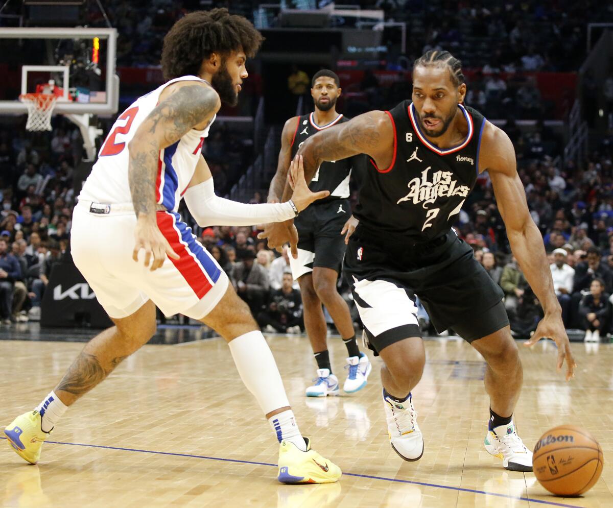 Clippers forward Kawhi Leonard drives to the basket against Detroit Pistons forward Isaiah Livers.