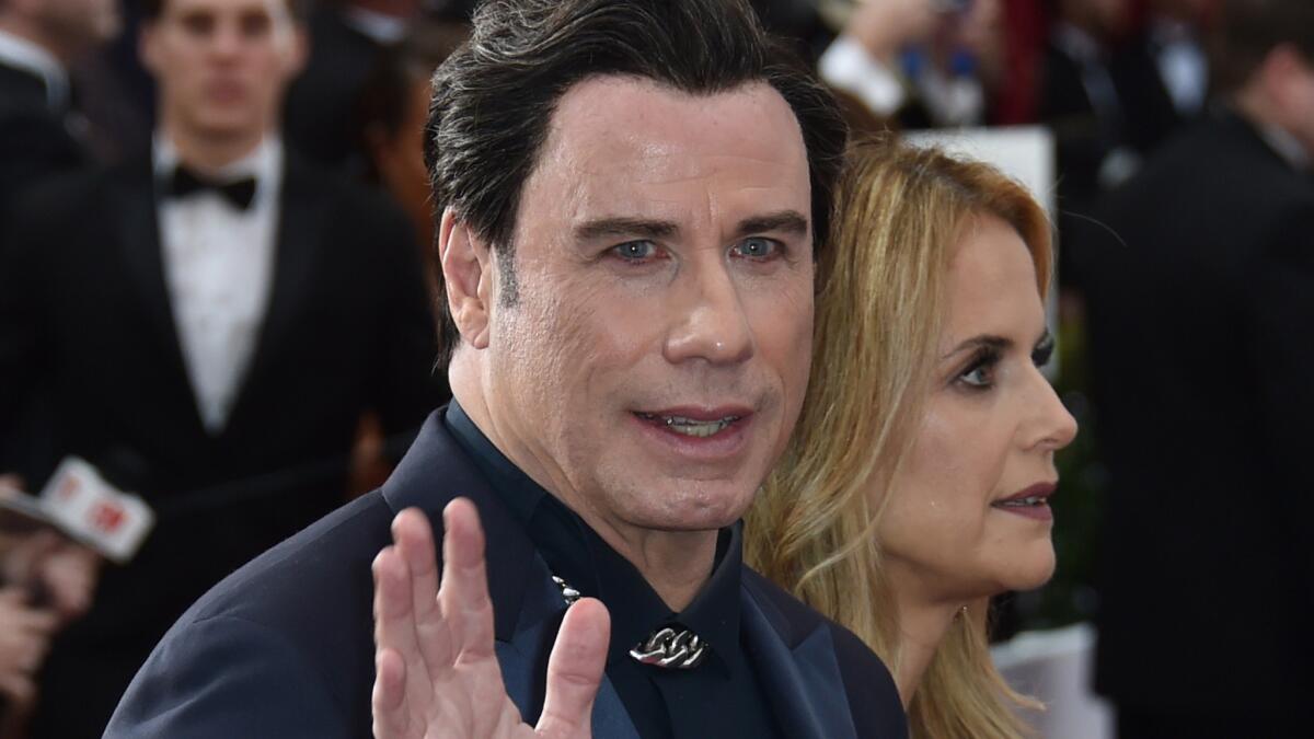 John Travolta, seen arriving at the Oscars in February with wife Kelly Preston, says his family has "done so well" with Scientology.