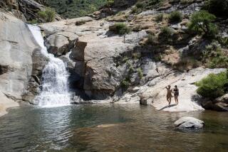 Julian, California - May 24: Armando Versaggi, 25, left, and Brianna Belleville, 22, prepare to go for a dip after completing a four mile hike on the Cha'chaany Hamuk Trailhead, formerly known as the Three Sisters Falls Trailhead on Friday, May 24, 2024 in Julian, California. The popular hike has undergone changes including a new parking lot and picnic benches. (Ana Ramirez / The San Diego Union-Tribune)