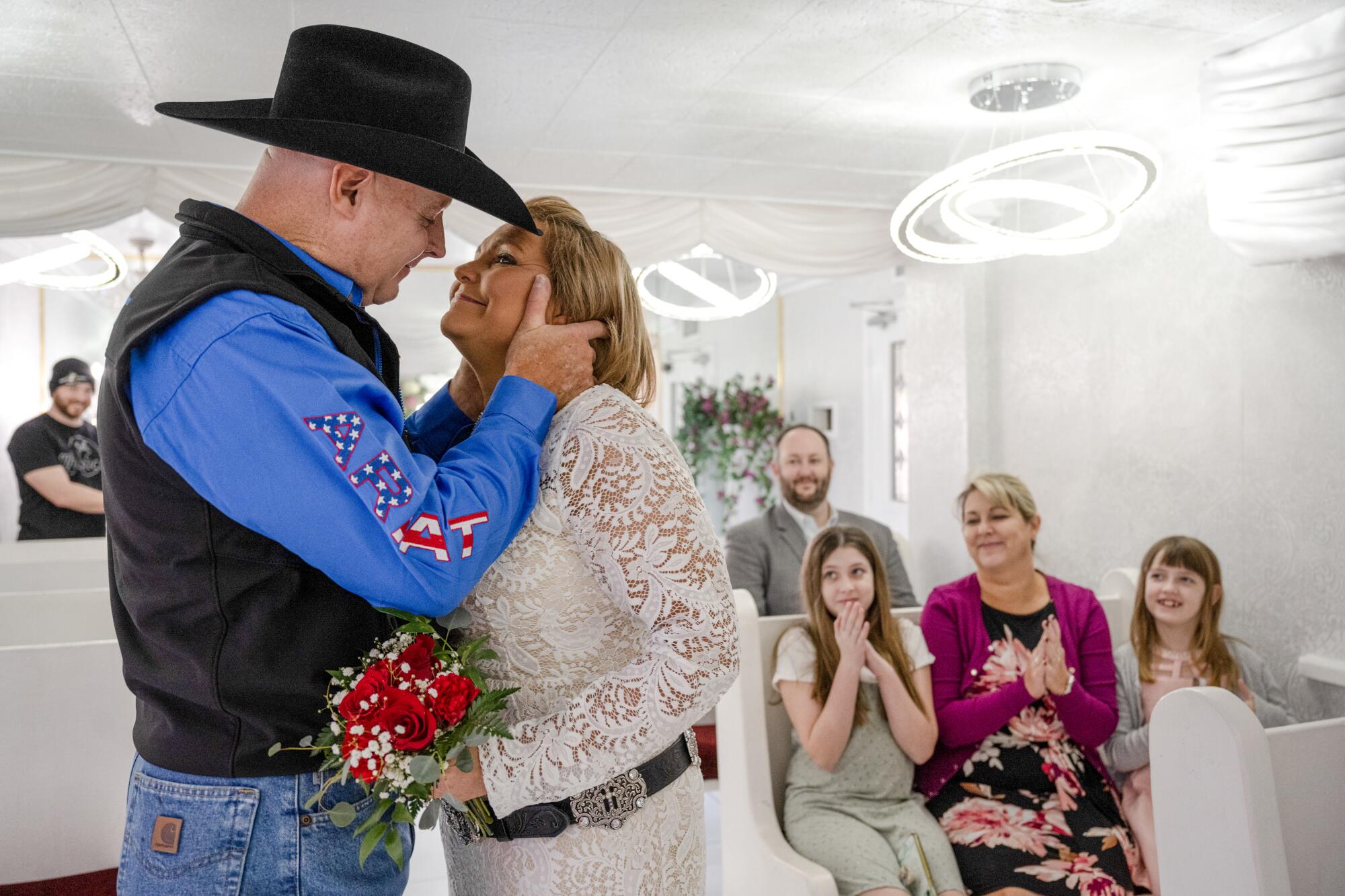 Two people kiss as others look on