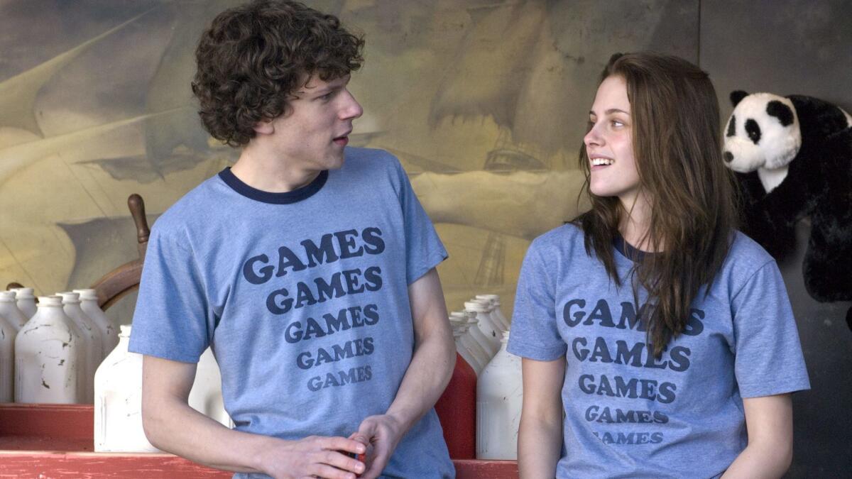 Jesse Eisenberg and Kristen Stewart are shown in a scene from "Adventureland."