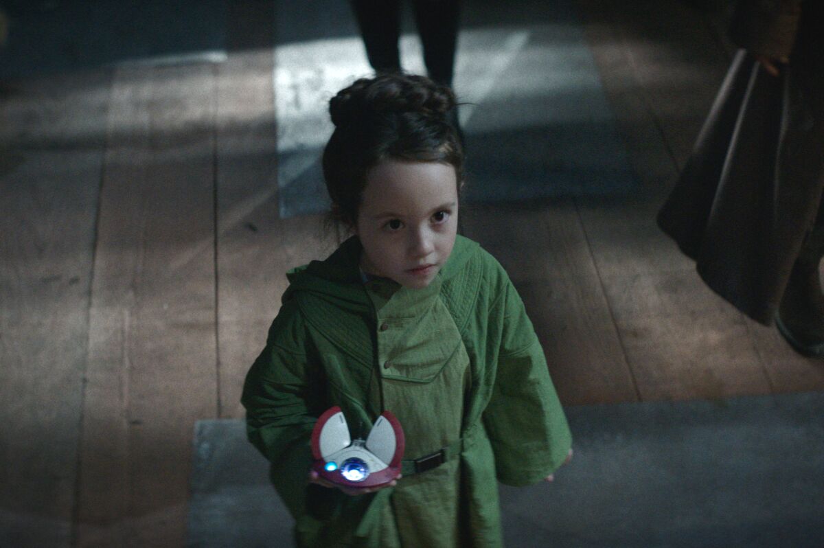 a girl holding a small robot