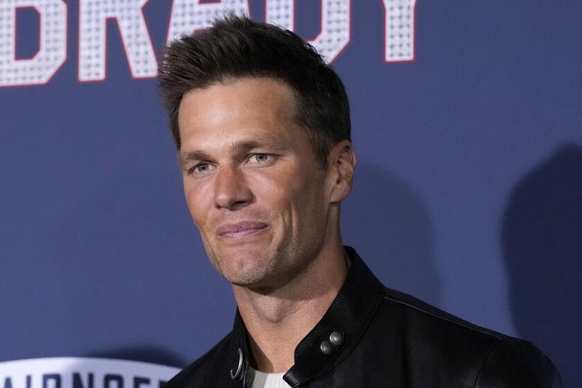 NFL quarterback Tom Brady, a cast member and producer of "80 for Brady," poses at the premiere of the film