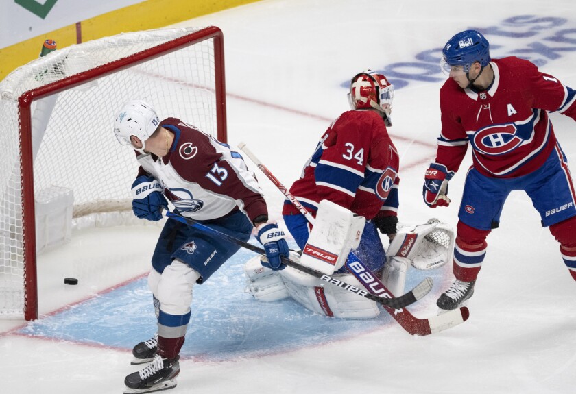 Colorado Avalanche right wing Valeri Nichushkin (13) watches his shot cross the goal line as Montreal Canadiens goaltender Jake Allen (34) and center Nick Suzuki (14) look on during second-period NHL hockey game action Thursday, Dec. 2, 2021, in Montreal. (Ryan Remiorz/The Canadian Press via AP)