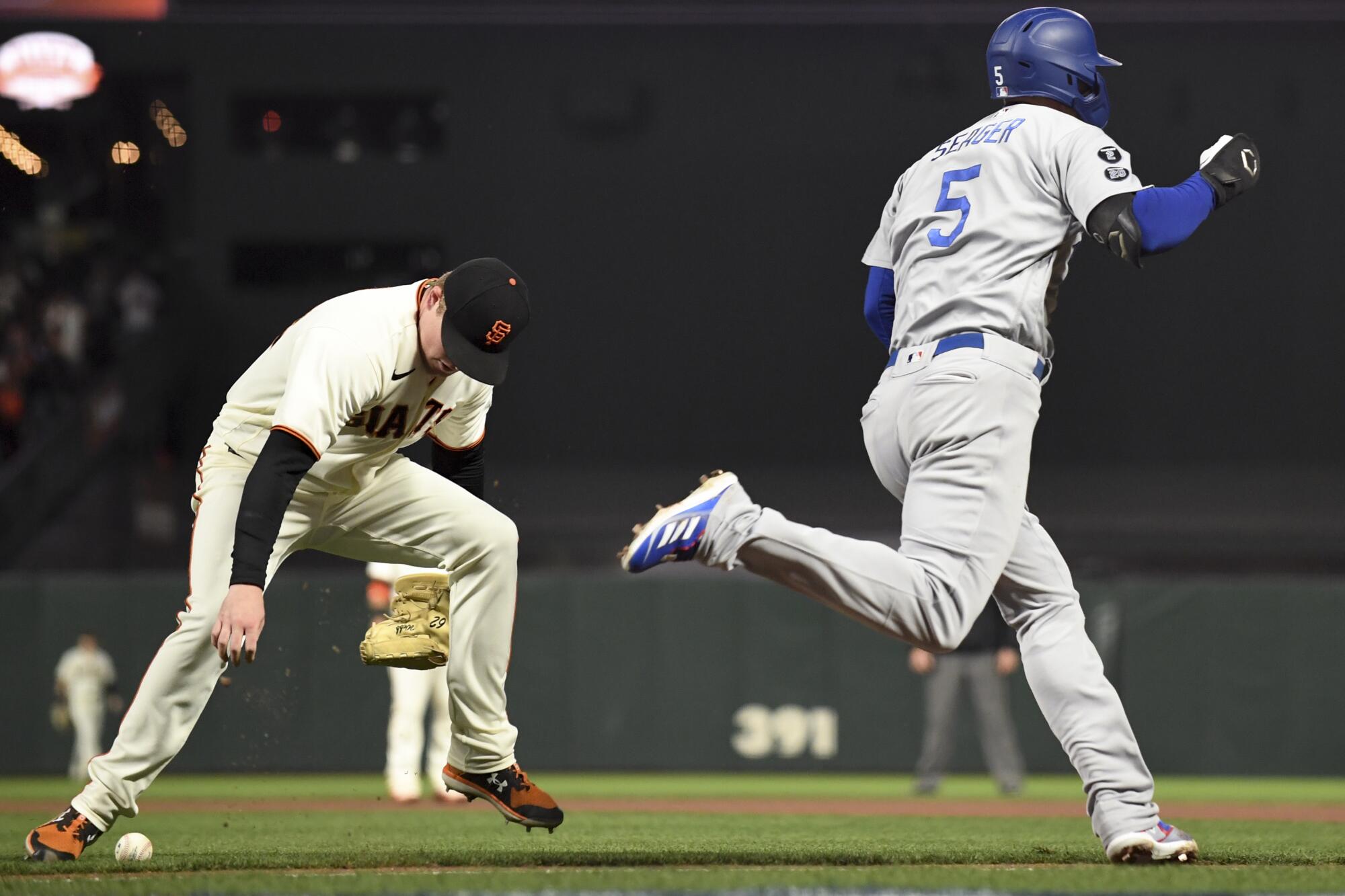 Dodgers' Corey Seager reaches first base on a fielding error.