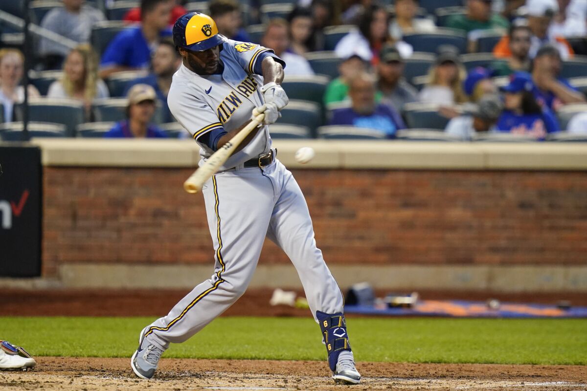 Milwaukee Brewers' Lorenzo Cain hits a single during the fourth inning of a baseball game against the New York Mets, Wednesday, June 15, 2022, in New York. (AP Photo/Frank Franklin II)