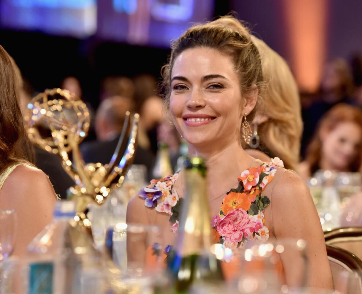 Supporting actress in a drama series winner Amelia Heinle beams at her table.