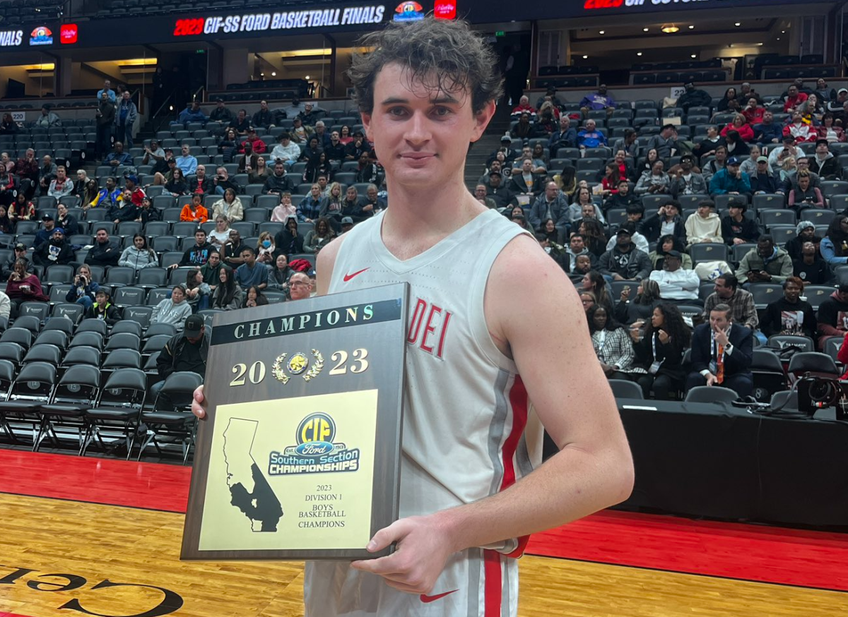 Mater Dei's Zack Davidson holds the boys' basketball Southern Section Division 1 championship plaque.