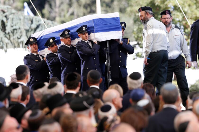 Knesset guards carry the flag-draped coffin during the funeral for former Israeli President Shimon Peres at the Mount Herzl national cemetery in Jerusalem on Friday.