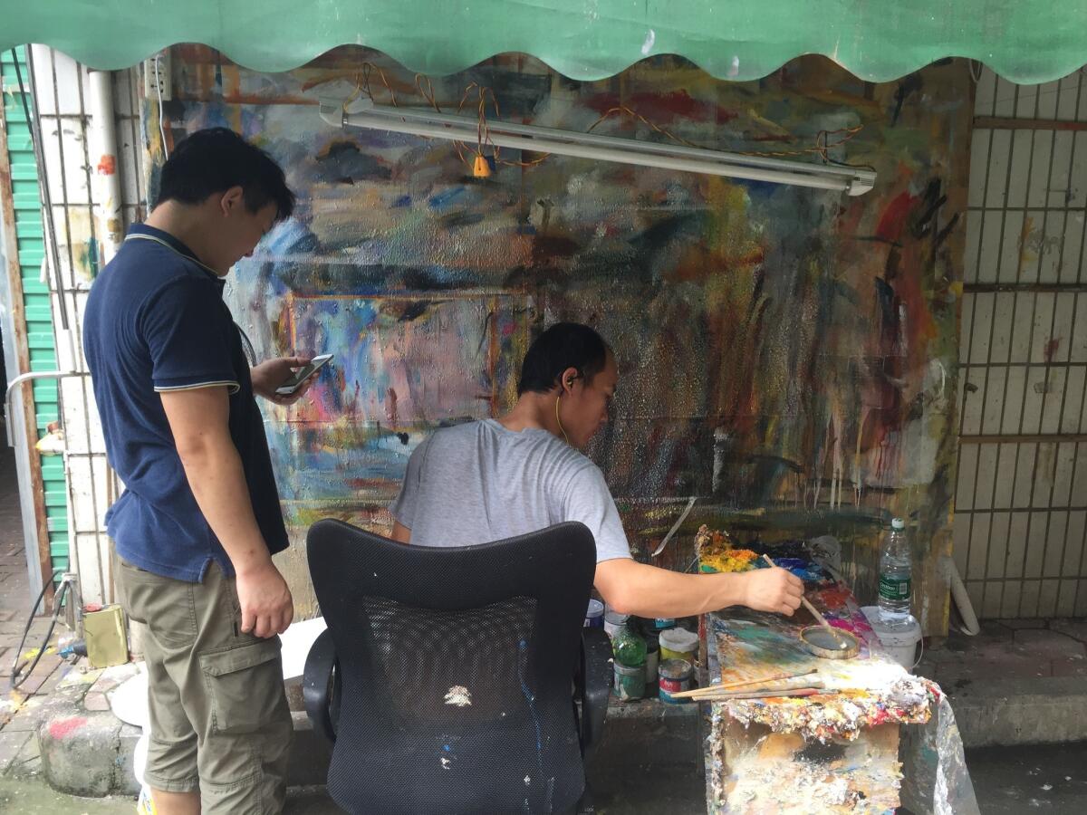 Artists work in Dafen Oil Painting Village in China.