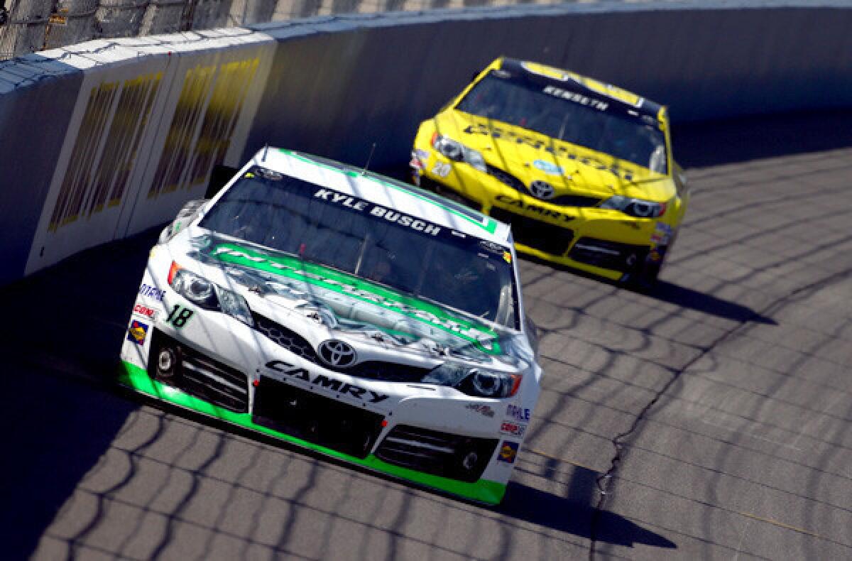 Kyle Busch leads Matt Kenseth during the early stages of the NASCAR Sprint Cup Auto Club 400 race in Fontana on Sunday.