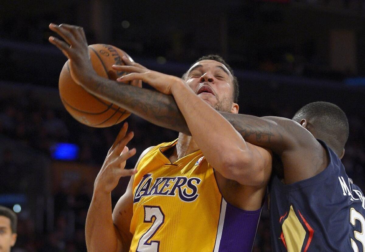 Elias Harris (2) is fouled by New Orleans guard Anthony Morrow during one of the two Laker games Harris played in this season.
