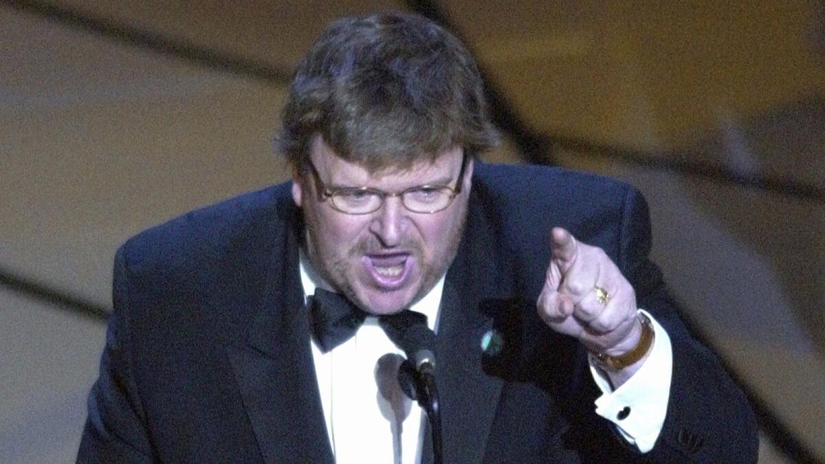 Michael Moore speaks out against President George W. Bush and the war in Iraq, which had begun just days earlier, after accepting the Oscar for best documentary feature for the film "Bowling for Columbine."