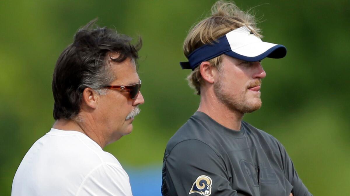 Rams Coach Jeff Fisher, left, and General Manager Les Snead watch practice on Aug. 4, 2015, in St. Louis.