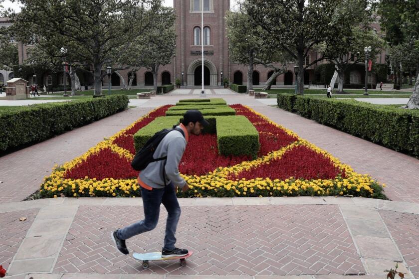 The USC campus and the scene outside Bovard Hall. The university faces a crisis over misconduct allegations against the campus' longtime gynecologist that has prompted calls for President C.L. Max Nikias to step down.