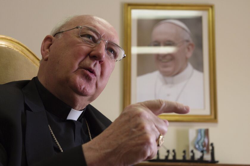 FILE-- Cardinal Camerlengo Kevin Farrell talks during an interview with The Associated Press in his office in Rome, Tuesday, July 31, 2018. During the period between the end of one pontificate and the election of a new pope the camerlengo, or chamberlain, runs the administration and finances of the Holy See, but under canon law Pope Francis was still pope, fully in charge of running the Vatican and the 1.3-billion-strong Catholic Church, even while unconscious and undergoing surgery Wednesday, June 7, 2023, to repair a hernia in his abdominal wall. (AP Photo/Paolo Santalucia)