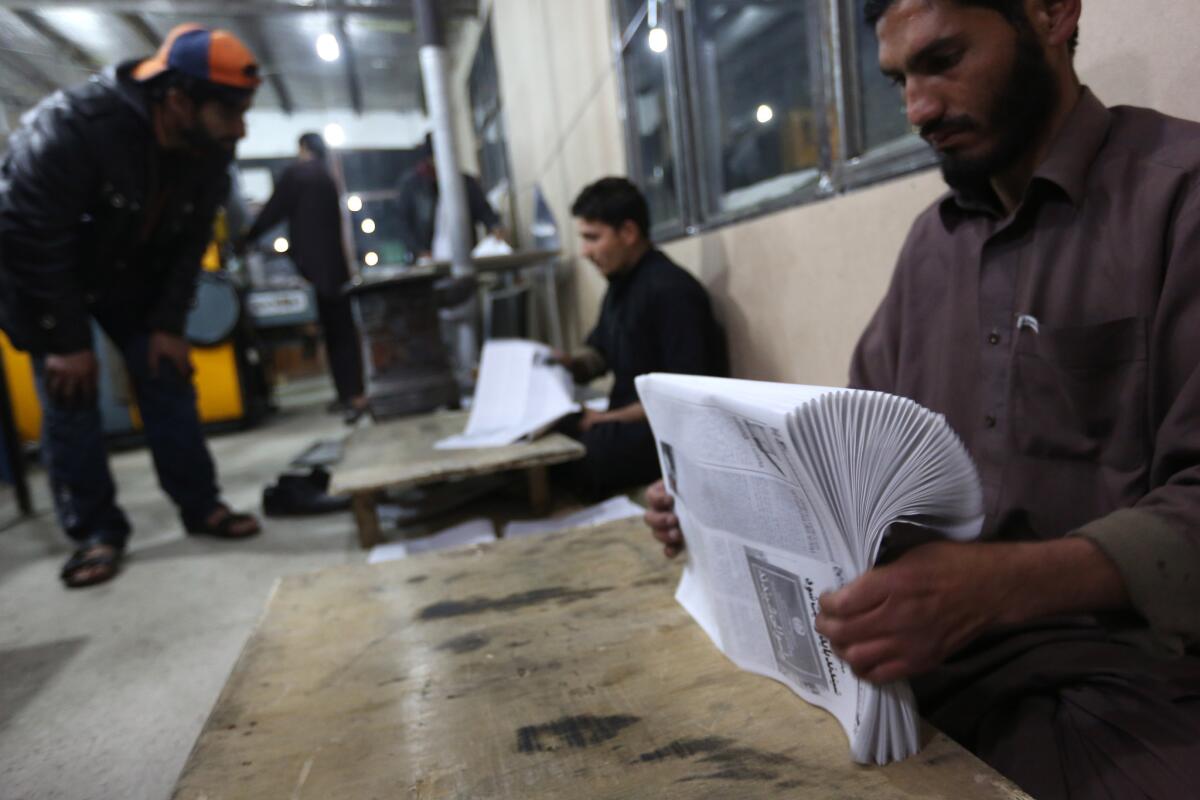 Workers arrange newspapers at a printing shop in Kabul, Afghanistan, on Jan. 18. A new Human Rights Watch report says perpetrators of violence against journalists are rarely punished, reflecting a "wider impunity and failure to establish the rule of law in Afghanistan."