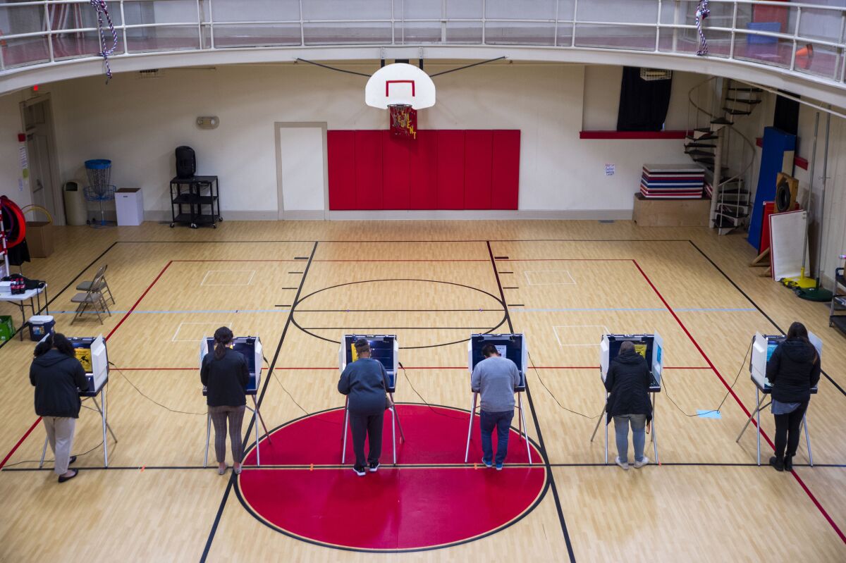 Voters fill out their ballots in the gymnasium at Robert S. Payne Elementary School in Lynchburg, Va., on Tuesday, Nov. 2, 2021. (Kendall Warner/The News & Advance via AP)